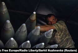 A Ukrainian serviceman stands in a truck with rockets for a BM-21 Grad multiple launch system during Russia's attack on Ukraine, near the frontline town of Bakhmut, Ukraine, May 19, 2023. (Radio Free Europe/Radio Liberty/Serhii Nuzhnenko/Reuters)