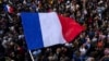 FILE - The French flag flies at Republique plaza, July 3, 2024, in Paris.