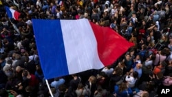 FILE - The French flag flies at Republique plaza, July 3, 2024, in Paris.