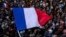 FILE - The French flag flies at Republique plaza, July 3, 2024, in Paris.