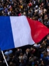 FILE - The French flag flies at Republique plaza, July 3, 2024, in Paris.