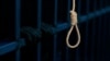 (FILE) A noose in front of hands on prison cell bars