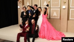 Daniel Kwan, Daniel Scheinert and Jonathan Wang pose with the Oscar for Best Picture for "Everything Everywhere All at Once" along with cast Jamie Lee Curtis, Ke Huy Quan, Michelle Yeoh, Stephanie Hsu and James Hong at the 95th Academy Awards in Los Angeles, March 12, 2023. 