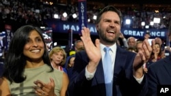 Republican vice presidential candidate Sen. JD Vance, R-Ohio, and his wife Usha Chilukuri Vance arrive on the floor during the first day of the 2024 Republican National Convention at the Fiserv Forum, in Milwaukee, July 15, 2024.