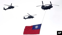 Helicopters fly over with Taiwan national flag during an inauguration celebration of Taiwan's President Lai Ching-te in Taipei, Taiwan, on May 20, 2024. 