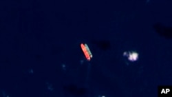 FILE - In this satellite photo provided by Planet Labs PBC, vessels identified as the Virgo, left, and the Suez Rajan, by the advocacy group United Against Nuclear Iran, are seen in the South China Sea on Feb. 13, 2022. 