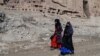 FILE - Afghan women walk near the site of the Buddhas of Bamiyan statues, which were destroyed by the Taliban in 2001, in Bamiyan province, Afghanistan, March 7, 2024. Bamiyan is the site of a gun attack on Western tourists on May 17, 2024.