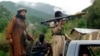 FILE - Members of the Pakistani Taliban, known as the TTP, patrol in Shawal, in the Pakistani tribal region of South Waziristan, Aug. 5, 2012.