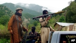 FILE - Pakistani Taliban patrol in Shawal, in the Pakistani tribal region of South Waziristan, Aug. 5, 2012. The Taliban win in Afghanistan in August 2021 has given a boost to militants in neighboring Pakistan.