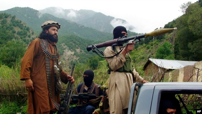 FILE - Pakistani Taliban patrol in Shawal, in the Pakistani tribal region of South Waziristan, Aug. 5, 2012. The Taliban win in Afghanistan in August 2021 has given a boost to militants in neighboring Pakistan.