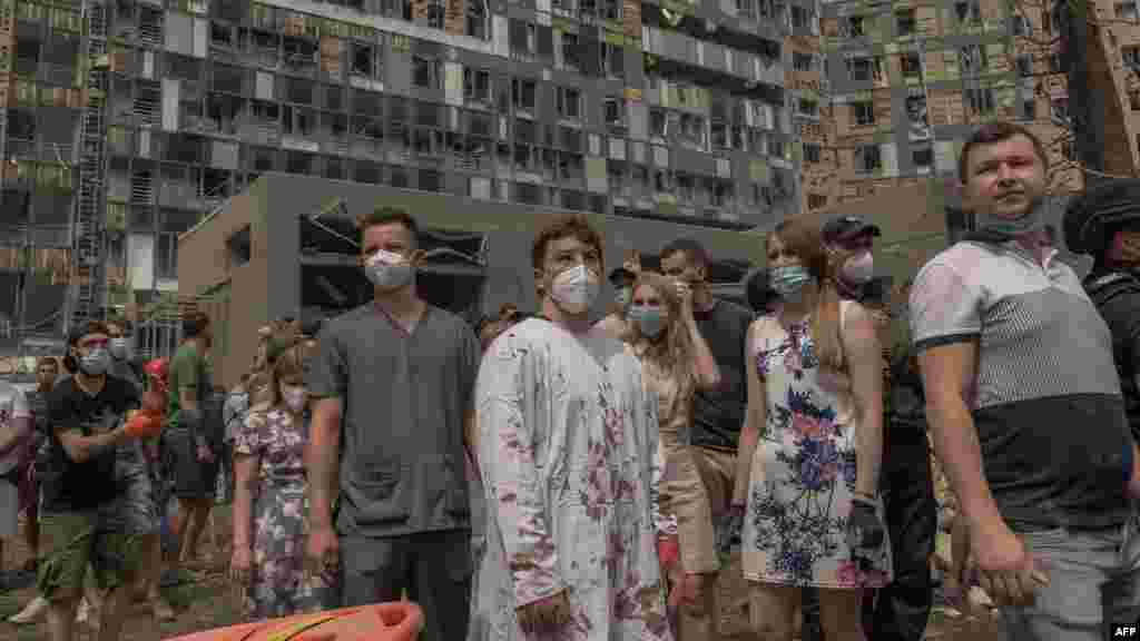 Medical personnel stand amid the rubble of the destroyed building of Okhmatdyt children's hospital following a Russian missile attack in the Ukrainian capital of Kyiv on July 8, 2024, amid Russian invasion in Ukraine.