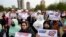 FILE - Afghan refugees hold placards during a rally protesting U.S. visa processing delays, in Islamabad, Pakistan, Feb. 26, 2023.