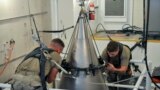 Senior Airman Jacob Deas, 23, left, and Airman 1st Class Jonathan Marrs, 21, right, secure the titanium shroud at the top of a Minuteman III intercontinental ballistic missile on Aug. 24, 2023, at the Bravo 9 silo at Malmstrom Air Force Base in Montana. (U.S. Air Force)