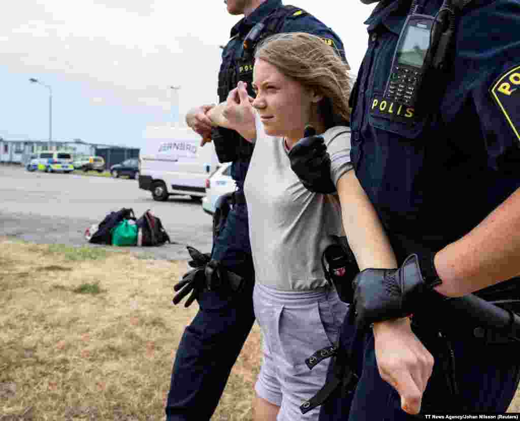 Police remove Greta Thunberg as they move climate activists from the organization Ta Tillbaka Framtiden, who are blocking the entrance to Oljehamnen in Malmo, Sweden, June 19, 2023.