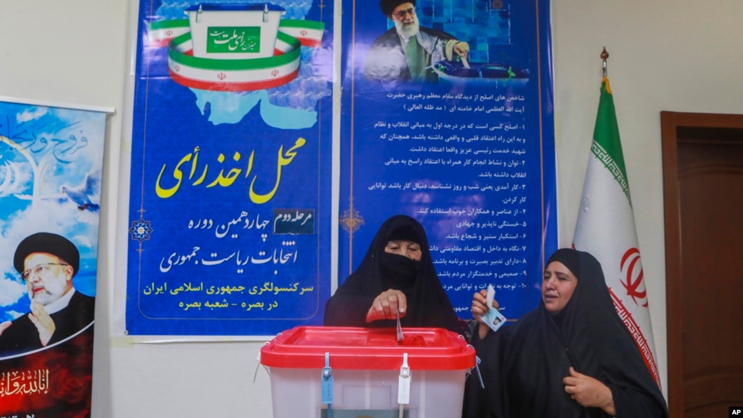 Iranian citizens cast their votes during the second round of the Iranian presidential elections at the Iranian consulate in Basra, southeast of Baghdad, Iraq, July 5, 2024. 