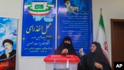 Iranian citizens cast their votes during the second round of the Iranian presidential elections at the Iranian consulate in Basra, southeast of Baghdad, Iraq, July 5, 2024. 