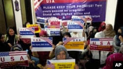 FILE - Afghan refugees hold an indoor rally in Islamabad, Pakistan, July 21, 2023, to demand their U.S. visas be processed. Many Afghans in Pakistan awaiting special immigration to the United States face deportation back to Afghanistan.