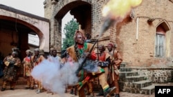A Bamoun warrior responsible of the security of the Sultan King of the Bamouns shoots into the air during the start of the inauguration ceremony of the new Bamoun Kings Museum in Foumban, on April 13, 2024.