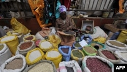 FILE - Vendors sell beans and rice in a street market in Kabete, on the outskirts of Nairobi on June 8, 2015.