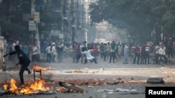 Supporters of the Bangladesh Nationalist Party throw bricks toward police during a clash in Dhaka, Bangladesh, Oct. 28, 2023.