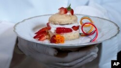 A chef holds a dessert, a rose and cardamom-infused strawberry shortcake, that will be served at Thursday evening's State Dinner with India, during a media preview, June 21, 2023, at the White House