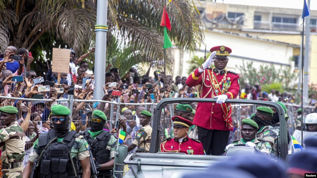 Gabon coup leader General Brice Oligui Nguema waves after being sworn in as interim president during his swearing-in ceremony, in Libreville, Gabon, Sept. 4, 2023. 