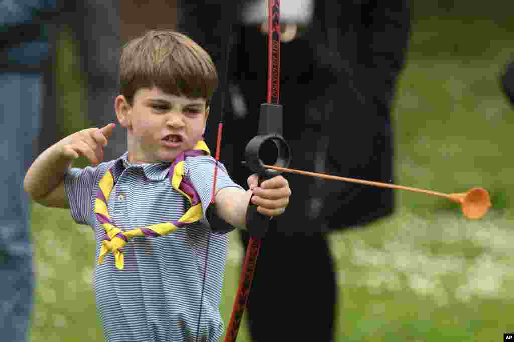 Britain&#39;s Prince Louis tries his hand at archery while taking part in the Big Help Out, during a visit to the 3rd Upton Scouts Hut in Slough, England.