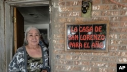 Barbara Finley, who hosts the image of San Lorenzo, or Saint Lawrence, poses for a photo in her doorway in Bernalillo, New Mexico, April 17, 2023.