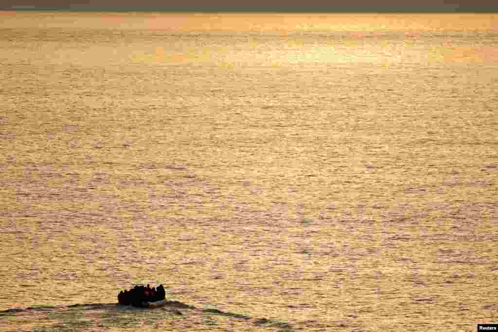 A group of migrants on an inflatable dinghy is seen during sunrise from the French rescue vessel &quot;Abeille Normandie&quot; as they try to cross the English Channel from the coast of northern France, Oct. 2, 2023.&nbsp;REUTERS/Pascal Rossignol&nbsp;