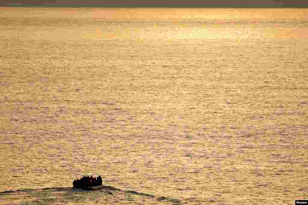 A group of migrants on an inflatable dinghy is seen during sunrise from the French rescue vessel &quot;Abeille Normandie&quot; as they try to cross the English Channel from the coast of northern France, Oct. 2, 2023.&nbsp;