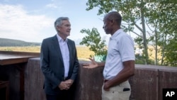 Federal Reserve Chairman Jerome Powell, left, chats with economist Philip Jefferson outside of Jackson Lake Lodge during the Jackson Hole Economic Symposium near Moran in Grand Teton National Park, Wyo., Aug. 25, 2023. 