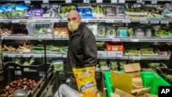 Joe Holtz, co-founder and general manager at Brooklyn's Park Slope Co-Op grocery store, Dec. 7, 2023, in New York. The store requires shoppers to mask up Wednesdays and Thursdays. 