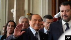 FILE - Forza Italia's president Silvio Berlusconi waves, center, flanked by The League leader Matteo Salvini, right, and Senator Licia Ronzulli, left, as they arrive at the Quirinale Presidential Palace, Oct. 21, 2022.