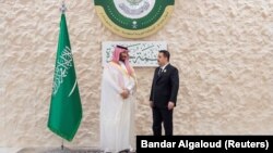 (FILE) Saudi Arabia's Crown Prince Mohammed bin Salman speaks with Iraqi Prime Minister Mohammed Shia al-Sudani, ahead of the Arab League Summit.