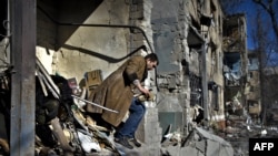 A local resident looks for his belongings after a shelling in Kramatorsk, eastern Ukraine, March 14, 2023.