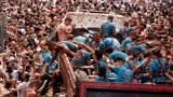 Revelers throw tomatoes at each other during the annual "Tomatina" tomato fight fiesta, in the village of Bunol near Valencia, Spain, Aug. 30, 2023. 