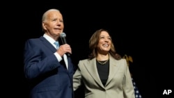 President Joe Biden, left, and Democratic presidential nominee Vice President Kamala Harris speak in Largo, Maryland, Aug. 15, 2024.