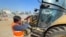 Akin Bozkurt operates a bulldozer at the site of collapsed buildings, taking part in the efforts to find bodies under rubble in the aftermath of the deadly earthquake in Kahramanmaras, Turkey, Feb. 18 2023. 