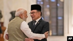 Indian Prime Minister Narendra Modi, left, welcomes his Malaysian counterpart Anwar Ibrahim upon his arrival at the Indian presidential palace during his ceremonial reception in New Delhi, Aug. 20, 2024.