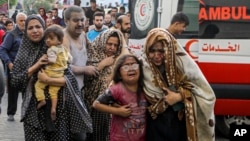 Wounded Palestinians arrive to al-Shifa hospital following Israeli airstrikes on Gaza City, central Gaza Strip, Oct. 16, 2023.