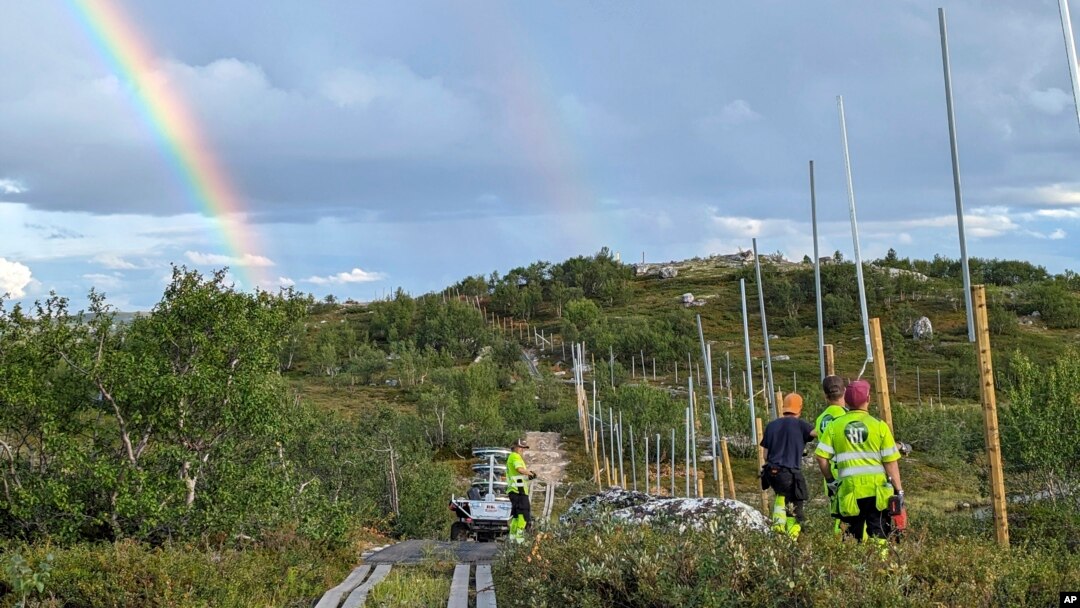 Workers build a new fence along the border with Russia, next to Storskog, Norway, Aug. 23, 2023. Norway is re-building a section of fence in the Arctic along its border with Russia to contain wandering reindeer, Norwegian officials said.