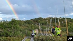 Workers build a new fence along the border with Russia, next to Storskog, Norway, Aug. 23, 2023. Norway is re-building a section of fence in the Arctic along its border with Russia to contain wandering reindeer, Norwegian officials said.