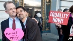 FILE - John Lewis, left, and Stuart Gaffney embrace outside San Francisco's City Hall shortly before the U.S. Supreme Court ruling cleared the way for same-sex marriage in California, June 26, 2013. 