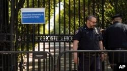 Police officers stand guard outside Columbia University in New York City, May 2, 2024.