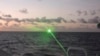 FILE - This photo provided by the Philippine Coast Guard shows a green military-grade laser light from a Chinese coast guard ship in the disputed South China Sea on Feb. 6, 2023. 