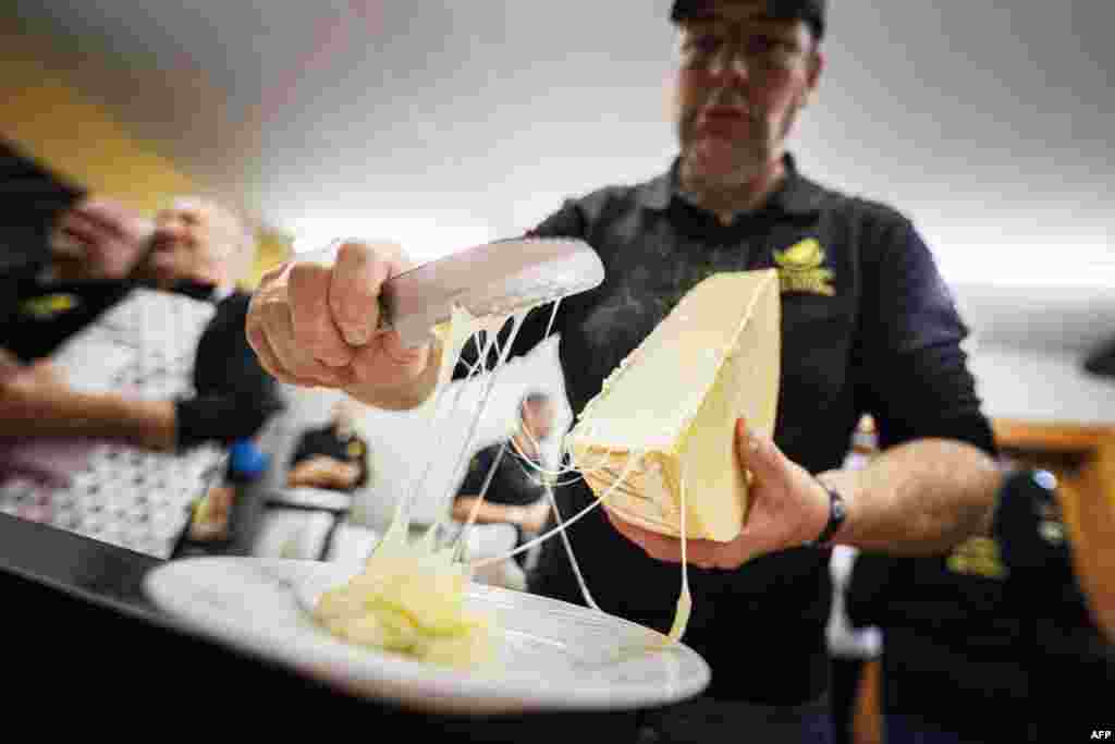 A &quot;scaper&quot; prepares a raclette during the first-ever Raclette World Championships featuring local and international raclette cheeses, in Morgins, Switzerland, Oct. 28, 2023.