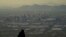 FILE - A man overlooks downtown Phoenix at sunset atop South Mountain, Sunday, July 30, 2023. Phoenix hit its 31st consecutive day of at least 110 degrees Fahrenheit (43.3 Celsius). 