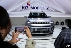 FILE - KG Mobility Torres EVX electric vehicle is unveiled during the media day at the Seoul Mobility Show in Goyang, South Korea, March 30, 2023.