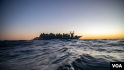 FILE - Migrants and refugees from various African countries in the Mediterranean Sea.
FILE - Migrants and refugees from various African countries aboard a wooden boat in the Mediterranean Sea.