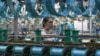中国安徽省阜阳市一名丝绸纺织厂女工在工作。(2024年4月16日)
